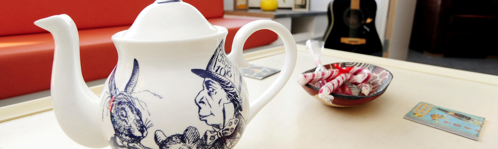 Image of tea pot on a coffee table.