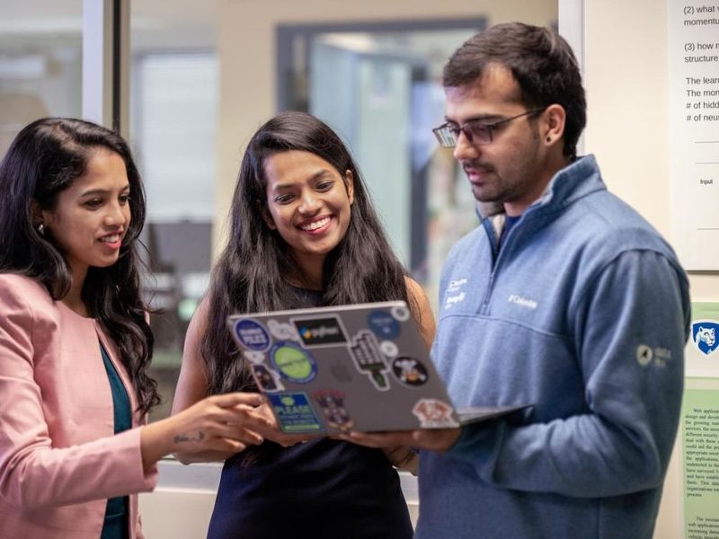 Students looking at a laptop 