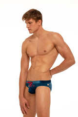 Marcuse Burleigh swim brief in navy stretch velvet with red external drawstring.