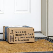 Amazon package sitting on doormat in front of door