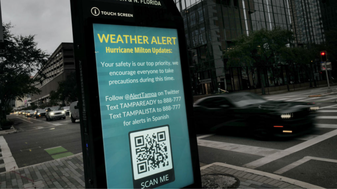 A weather alert is displayed along a sidewalk as Hurricane Milton churns in the Gulf of Mexico on October 07, 2024 in Tampa, Florida. Milton, which comes on heels of the destructive Hurricane Helene, has strengthened to a Category 5 storm as it approaches Florida’s Gulf Coast near Tampa, where it is projected to make landfall Wednesday.