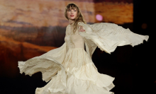 Taylor Swift performing in a gauzy white dress. 