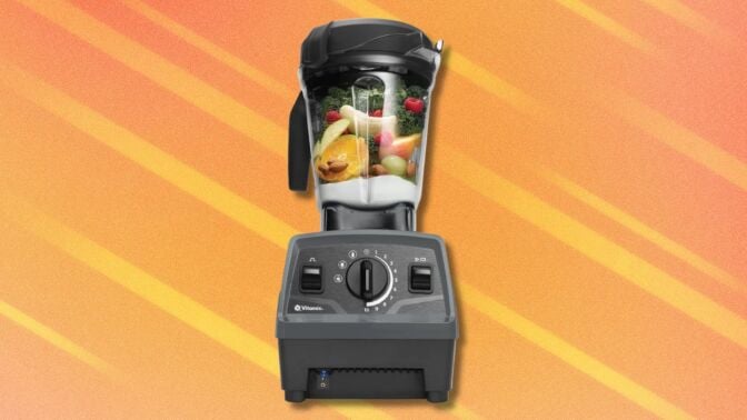 a vitamix explorian blender filled with fruits, vegetables, and milk 