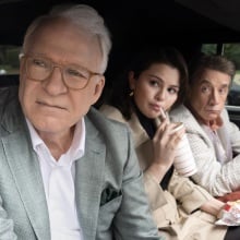 Charles, Mabel, and Oliver in the backseat of a car.