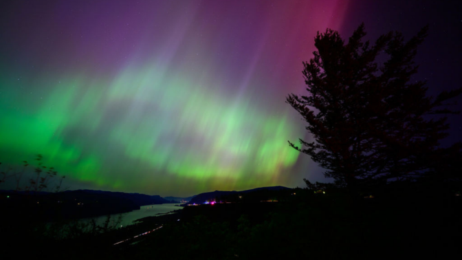 The Northern Lights are seen above the Columbia River Gorge from Chanticleer Point Lookout in the early morning hours of May 11, 2024 in Latourell, Oregon.