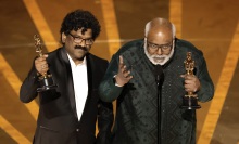 Chandrabose and M.M. Keeravani hold Oscars onstage at the Academy Awards.