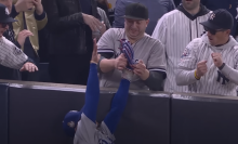 yankee fan taking ball from mookie betts