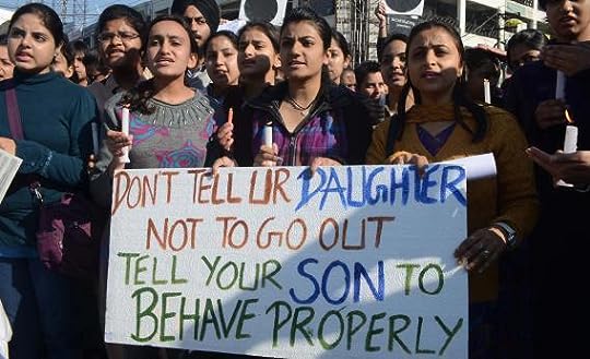 protesters holding a sign that says 'don't tell your daughter not to go out, tell your son to behave properly'