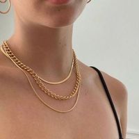 How to layer gold necklaces to dress up a casual outfit #goldjewelry #goldnecklace #layering