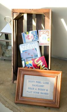 a small wooden box filled with books next to a framed sign that says don't feel like dancing