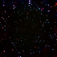 an image of some very bright lights in the dark night sky with stars all over it