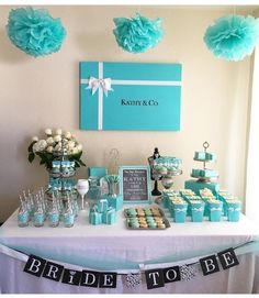 a table topped with lots of cupcakes and cake next to a sign that says bride to be