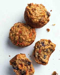 three muffins sitting on top of a white surface