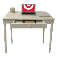 an open laptop computer sitting on top of a white wooden desk with drawers underneath it