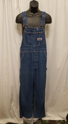 Vintage 1980s Big Mac Dark Wash Overalls Denim Bib Carpenter Dungarees, Workwear, Farm, Waist 36.  Excellent vintage condition - see pics! Overalls have a front 2 button closure, 2 deep side pockets, and 2 back pockets.  Shoulder straps are adjustable! Measurements: shoulder to shoulder 11 in, shoulder to bottom length 63, inseam 31, length from shoulder to crotch 33, top of bib 10 across, waist 36 inches. Vintage Dark Wash Bib Front Overalls, Vintage Denim Blue Bib Front Overalls, Vintage Denim Blue Overalls With Pockets, Vintage Straight Leg Overalls With Pockets, Vintage Denim Blue Jumpsuit With Pockets, Vintage Bib Front Denim Jumpsuit In Medium Wash, Vintage Medium Wash Denim Jumpsuit With Bib Front, Vintage Bib Front Medium Wash Bottoms, Vintage Medium Wash Bib Front Bottoms