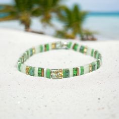 Explore our FIFI™ Tila Bead Bracelets--boho-chic essentials that add a pop of personality to any outfit. Handmade with love in Utah, these tile bracelets are crafted with the highest quality Japanese glass tila beads and a premium crystal elastic cord, ensuring strength, durability, and comfort. Perfect for layering, lightweight, waterproof, and ideal as a unique stocking stuffer, this boho tila bracelet suits any style, from modern to classic. Our bracelets are waterproof, durable, comfortable, Green Letter Beads For Festival, Bohemian Green Stretch Bracelet For Festival, Bohemian Green Bracelets With Spacer Beads, Bohemian Green Bracelet With Spacer Beads, Bohemian Stretch Bangle Bracelet With Letter Beads, Bohemian Green Heishi Beads Bracelets, Green Heishi Beads Summer Jewelry, Summer Green Heishi Beads Jewelry, Bohemian Heishi Beads Stretch Bracelet As Gift