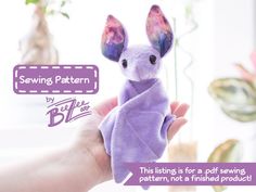 a hand holding a purple stuffed animal in it's left hand with the caption saying sewing pattern