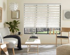 a living room filled with furniture and a window covered in blinds