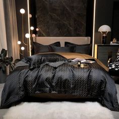 a black and gold bedroom with lights on the headboard, bedding and pillows