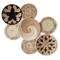 several woven baskets with black and white designs on the bottom one is round, two are circular