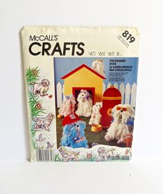 a magazine cover with three dogs in front of a small dog house and other toy animals