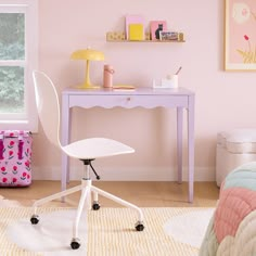 a white chair sitting in front of a pink desk