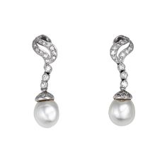 Elegant pair of vintage diamond & baroque pearl earrings crafted in 14k white gold (circa 1950s to 1960s).    Round brilliant diamonds total an estimated 0.50 carats (estimated at H-I color and VS2-SI2 clarity). The pearls measure 10.5mm each.    The elegant drop earrings exude glamor and style and make a great statement on the earlobe. Diamonds adorn the scrolled mounts with lustrous pearls to the base. The earrings are great for day or evening wear & are fitted with post & hinged omega backings for pierced ears.    The earrings are in very good condition and were recently lightly cleaned and polished.    Particulars:    Weight: 9.6 grams    Stones: Round brilliant diamonds total an estimated 0.50 carats (estimated at H-I color and VS2-SI2 clarity). The pearls measure 10.5mm each.    Size Exquisite Pearl Earrings For Evening With Elegant Design, Elegant Evening Pearl Earrings, Vintage White Diamond Earrings, Vintage White Diamond Earrings For Formal Occasions, Timeless Diamond Pearl Earrings For Evening, Elegant White Gold Earrings With 17 Jewels, Elegant Pear-shaped Pearl Earrings For Anniversary, Elegant Pear-shaped Diamond Earrings For Evening, White Gold Pearl Earrings With 17 Jewels For Wedding