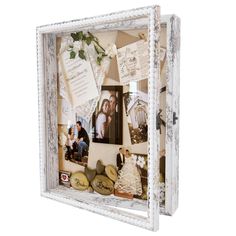 an old white frame with photos and pictures on the inside is decorated with paper flowers