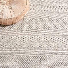 a round cushion sitting on top of a rug