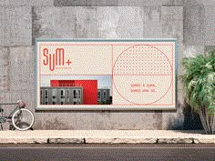 a bicycle parked on the side of a road next to a large advertisement for sun plus