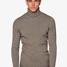 This soft taupe knitted sweater is
 tailored slim with a ribbed hem and cuffs, and heavy turtleneck collar. Fitted Beige Polo Sweater For Winter, Brown Turtleneck For Workwear, Formal Wool Turtleneck Sweater, Elegant Wool Turtleneck For Winter, Elegant Brown Turtleneck For Workwear, Beige Merino Wool Turtleneck For Fall, Classic Fitted Turtleneck For Work, Wool Turtleneck Sweater For Formal Occasions, Classic Fine Knit Turtleneck Sweater