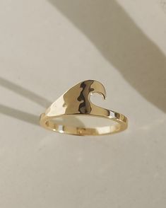 Material: 10k gold plated over brass Dimensions: 9mm (ring face) Coastal Fits, Ocean Rings, 9mm Ring, Gold Thumb Rings, Unique Gold Rings, Gold Wave Ring, Accessory Inspo, Preppy Jewelry, Gold Waves