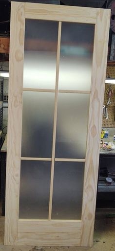 an unfinished glass door in a workshop