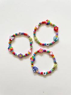 These unique Y2K-inspired bracelets are handmade by me with love. You will receive a bracelet that is very similar to the ones in the pictures with a fun and vibrant rainbow color-theme. Bracelets also come with kawaii charms like the flowers, butterfly, pastel pink heart, and smiley face. 🦋 If you want to customize this bracelet, feel free to add a name, initials, or short phrase in the personalization section. If you do not add a customization, you will receive the same bracelet but with no letters. Bracelets are perfect for stacking and are made with stretchy string so there's no need to worry about them snapping. Bracelets are also a super cute (birthday) gift idea for your bff(s)! For teenagers and women, we recommend our standard size of 6.5 inches, while kids may need a smaller siz Personalized Pink Jewelry For Festivals, Handmade Adjustable Playful Jewelry, Adjustable Multicolor Whimsical Beaded Bracelets, Fun Festival Bracelet Jewelry, Whimsical Adjustable Multicolor Beaded Bracelets, Playful Handmade Adjustable Jewelry, Whimsical Multicolor Jewelry For Friendship, Cute Multicolor Charm Bracelet For Jewelry Making, Handmade Kawaii Jewelry For Friendship