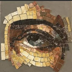 an eye made out of small tiles on the ground