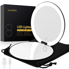 the light up mirror is next to its box and charger for charging batteries or other electronic devices