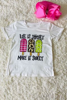 Top features 3 cute popsicles with different fun and perfect for summer prints on a solid white background t-shirt. Short sleeve normal daily wear. Super soft material, comfortable and easy. Add a sweet to her look with this printed short-sleeve top. Good to match a denim pant/shorts for spring and summer season. The prints design adds a playful design touch to her wardrobe. Breathable fabric keeps you cool and comfortable, while the pullover style makes it easier to wear. Material: Polyester and Spandex. Includes: Top Skirt Swimsuit, Spring Shorts, Prints Design, Mommy And Me Outfits, Baby Gown, Halloween School, Summer Prints, Girls Sweaters, Life Is Short