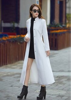 "This single breasted long wool coat made in minimalist style consist of stand collar, clear line and silouette, two seam pockets, about mid calf length that will be an utility and versatile coat for your wardrobe. If you need one simple and warm wool coat, it is. DETAIL * 50% wool, 50% fiber, nylon * Polyester lining * Two side pockets * Front hidden closure * Stand collar wool coat * Long wool coat * Belted wool coat * Fit for autumn-to-winter * Dry clean only *The model is 170 cm (5′7″) tall with a 80 cm (31.5\") bust, 66 cm (26\") waist. She is wearing in size XS. * Choose CUSTOM Order if you Can't find your size in our size Chart Chang the Length Your Height is not Between 5'1\" - 5\"9\" Your weight is not Between 47 kg - 75 kg SIZE GUIDE Size vary between Brand and Country Please get Winter White Coat, Over Size Coat, Female Coat, Long Overcoat For Women, Women's Coat, Dress Coats, White Long Coat Outfit, Woman Coat, White Coats