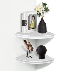 two white shelves with vases and books on them, one has a bird figurine