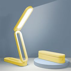 a yellow desk lamp sitting on top of a table