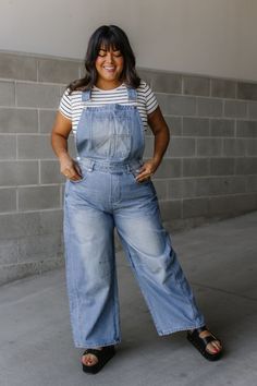 Calling all cool cats (and kittens)! These denim overalls are your new outfit BFF. They've got adjustable shoulder straps for the perfect fit, and classic pockets in the front and back to stash your essentials (hello, phone!). The barrel legs are relaxed and comfy, with a slouchy vibe that's effortlessly cool. Made from a medium wash denim, they're a wardrobe staple that goes with everything. Dress them up with a blouse or keep it casual with a tee - these overalls are ready for anything! Denim overalls Adjustable shoulder straps Classic front & back pockets Barrel leg Slouchy relaxed fit Medium wash 100% Cotton Fit and sizing:  Measurements are approximate. Length measurements are taken from the top of the shoulder to the bottom hem lying flat. Small - Waist: 30", Inseam: 27" Medium - Wai Medium Wash Denim Overalls With Adjustable Straps, Trendy Everyday Denim Jumpsuit With Pockets, Medium Wash Denim Overalls With Suspenders, Trendy Denim Jumpsuits And Rompers With Adjustable Straps, Trendy Medium Wash Overalls With Adjustable Straps, Trendy Denim Overall Jumpsuit For Everyday, Trendy Denim Jumpsuit With Adjustable Straps, Trendy Relaxed Fit Overalls With Adjustable Straps, Trendy Denim Overall Jumpsuit