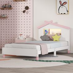 a child's bedroom with pink, white and grey decor on the walls is decorated in pastel colors