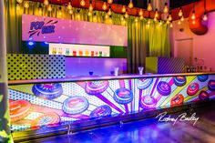 a brightly lit bar with neon lights in the background