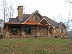 a large house sitting on top of a lush green field