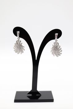 These earrings are absolutely gorgeous! They are made of sterling silver and are encrusted with cubic zirconia stones. They will add a touch of glamour to any outfit. The stones are high-quality and sparkle beautifully, and the sterling silver setting is very well-made.