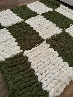 a green and white rug on the floor