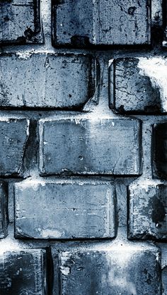 a black and white photo of an old brick wall with water droplets on it's surface