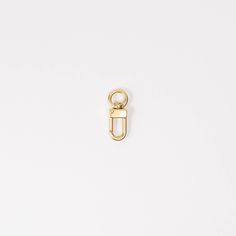 a gold metal clip on a white background