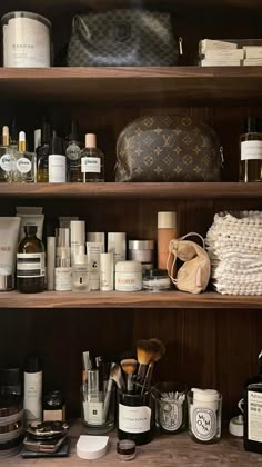 the shelves are full of cosmetics and personal care products, including an old louis vuitton bag