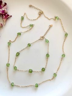 Adorn yourself in our Peridot Satellite Jewelry Set in your choice of sterling silver or gold filled chain makes such a sweet + thoughtful gift for yourself or someone special. This dainty gemstone jewelry style features a delicate chain punctuated by smooth Peridot gems at equal intervals, like the orbit of a satellite.  Pure sparkling green Peridot is the August Birthstone + wearing peridot jewelry opens the heart, encouraging creativity, increasing positivity + bringing good luck to your endeavors.  Our Peridot gemstone necklace + bracelet set is a simple, elegant + eye catching style. The adjustable length on both the necklace + bracelet makes this set an easy, luxurious gift for mom, sisters, girlfriends, bridesmaids, coworkers, August birthday babes + more! NECKLACE DETAILS CABLE CHA Dainty Gemstone Jewelry, Simple Jewellery, Peridot Crystal, August Birthday, Crystal Jewelry Sets, Peridot Jewelry, August Birthstone, Set Necklace, Jewelry Style